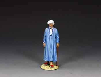 Image of "The Camel Owner"--single Arab figure leaning on cane