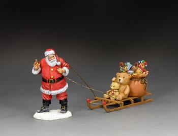 Image of Santa and His Sledge--single figure dragging a toboggan laden with toys