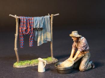 “Laundry Day", The Gold Rush--single kneeling figure scrubbing in basin, pitcher, laundry drying on line #51974