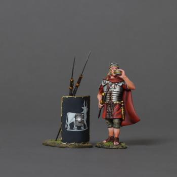 Image of Roman Soldier Wearing Cloak and Drinking from Canteen--cloaked figure and black 9th Legion shield with two leaning spears #52085