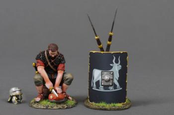 The Meat Cutter (B)--single Roman Legionary figure in Red tunic sitting on a bucket cutting meat, helmet, and two pila leaning on 9th Legion black shield #53061