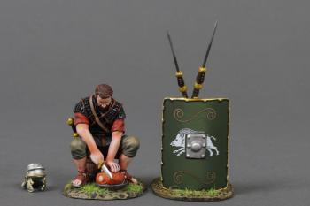 The Meat Cutter (C)--single Roman Legionary figure in Red tunic sitting on a bucket cutting meat, helmet, and two pila leaning on 19th Legion green shield #53062