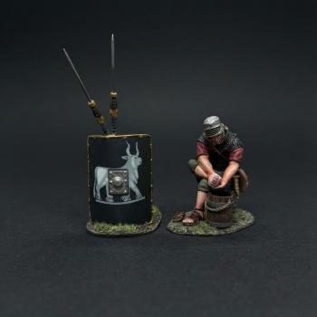 The Washerman with Black Shield (B)--single Roman Legionary figure seated on bucket & washing clothes and shield leaning on two spears  #53376