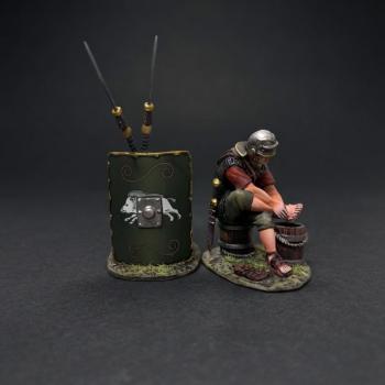 The Washerman with Green Shield (C)--single Roman Legionary figure seated on bucket & washing clothes and shield leaning on two spears  #53377