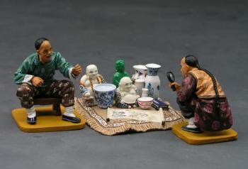 Image of Chinese Curio Seller--two crouching figures and curios